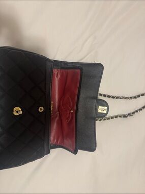 CHANEL Black Quilted Leather Shoulder Bag with Red Interior and Gold Hardware